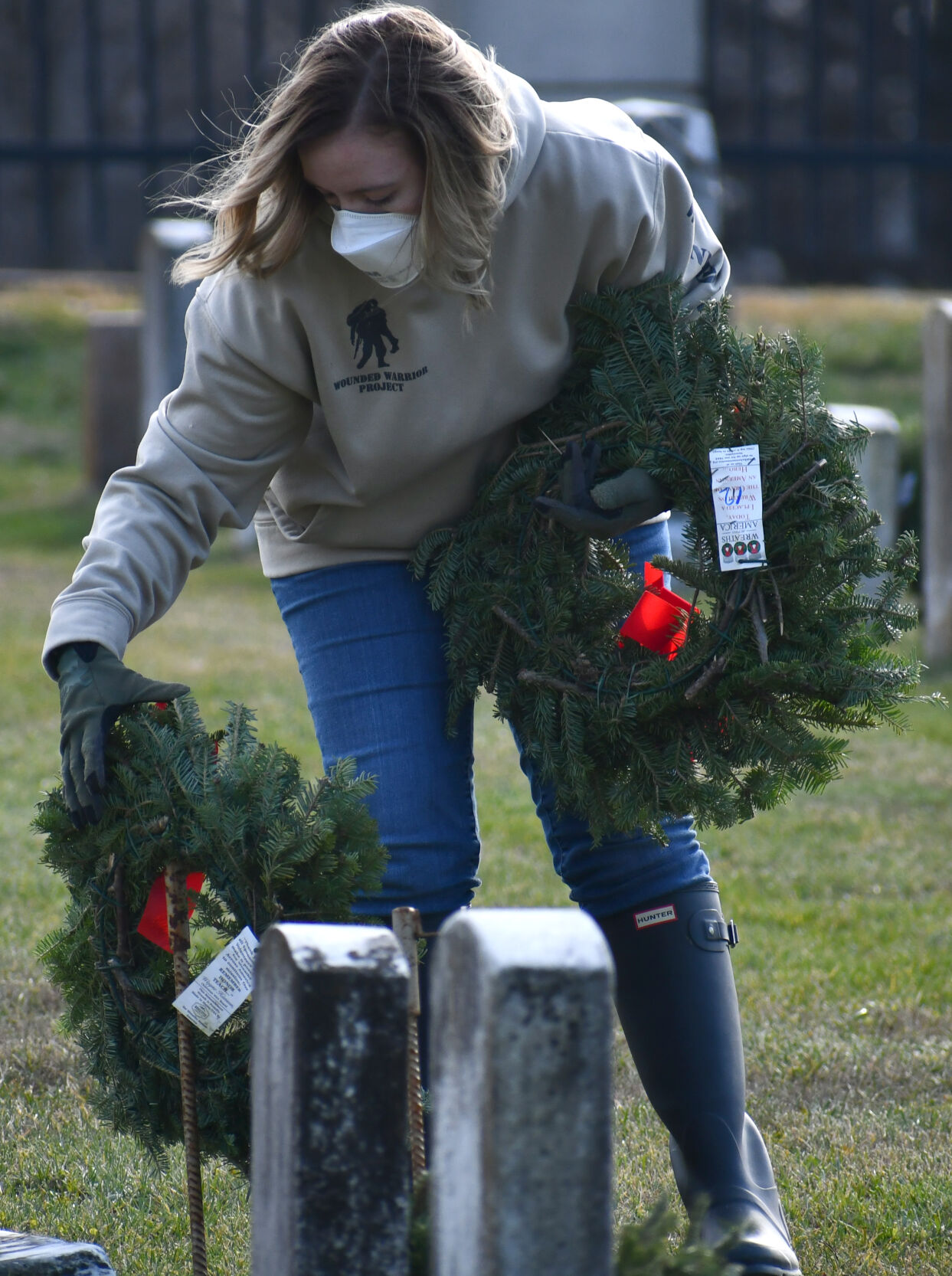 Brittany Ritter places a wreath